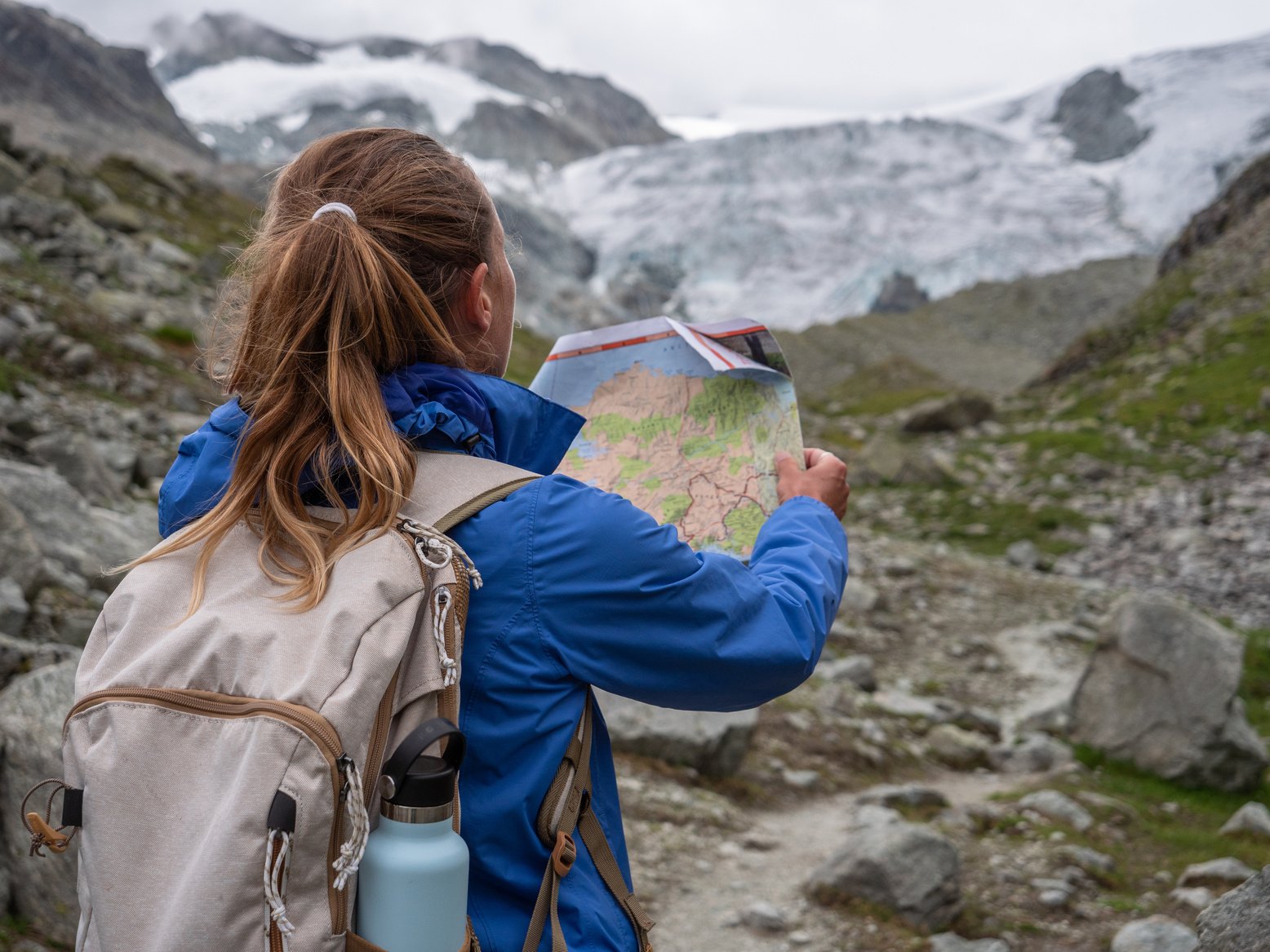 Hiker looking at trail map and directional signs