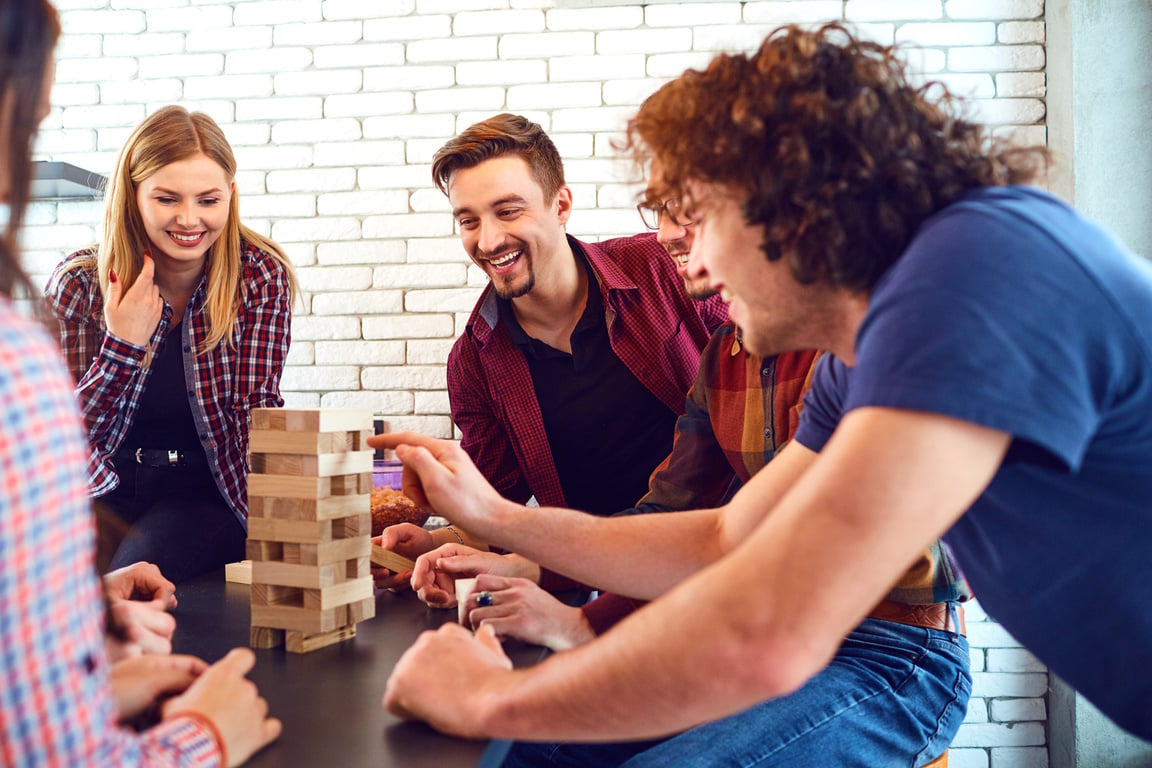 A Cheerful Group of Young People Play Board Games.